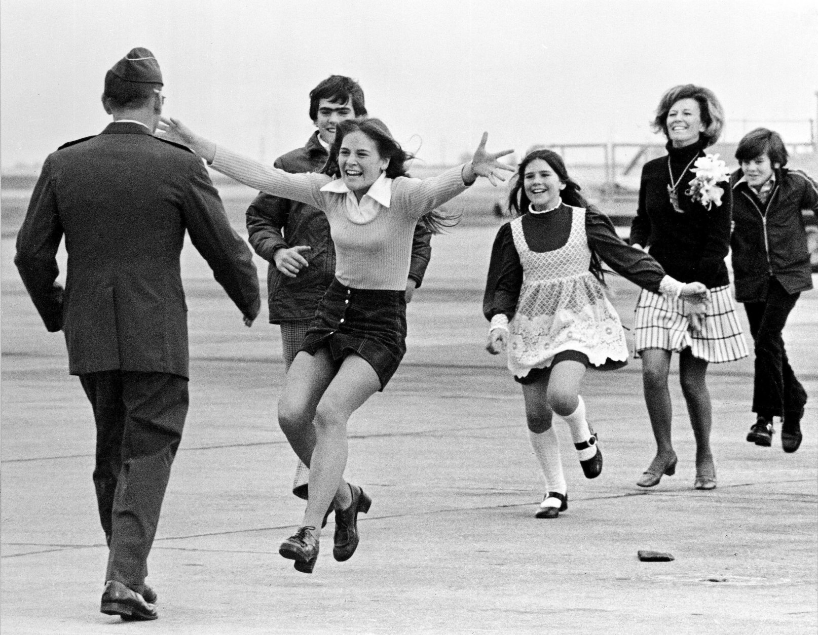 Released prisoner of war Lt. Col. Robert L. Stirm is greeted by his family at Travis Air Force Base in Fairfield, Calif., as he returns home from the Vietnam War, March 17, 1973.  In the lead is Stirm's daughter Lori, 15; followed by son Robert, 14; daughter Cynthia, 11; wife Loretta and son Roger, 12.  (AP Photo/Sal Veder)