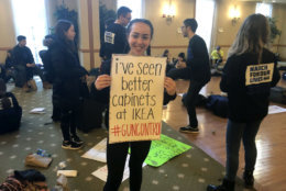 "We want to take fear out of the classroom," said Arielle Bauer, of Birmingham, Michigan, seen holding her sign in this photo. (WTOP/Melissa Howell)