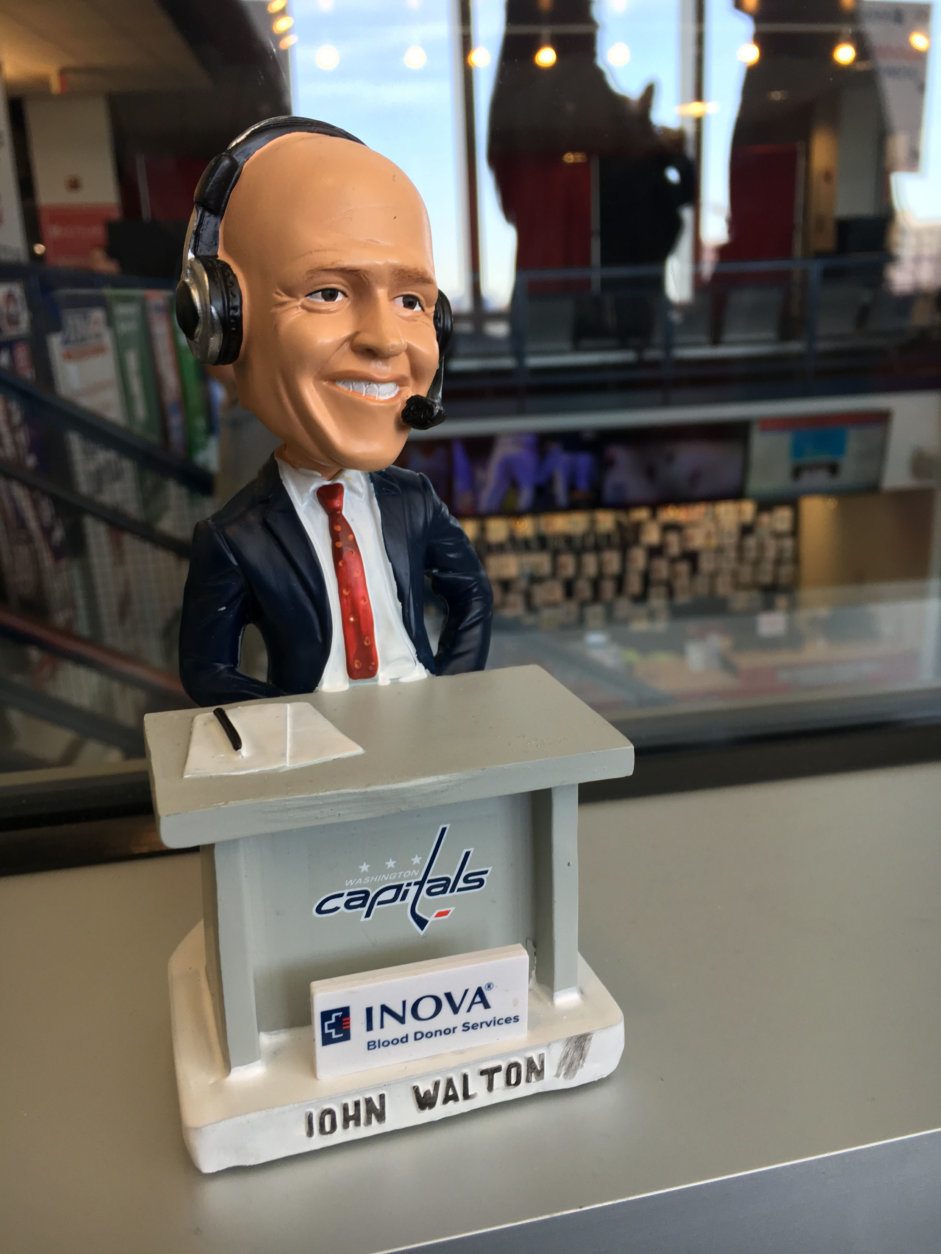 John Walton, the Caps radio play-by-play announcer, stopped by. He was immortalized as a bobble head for donors. (WTOP/Keara Dowd)