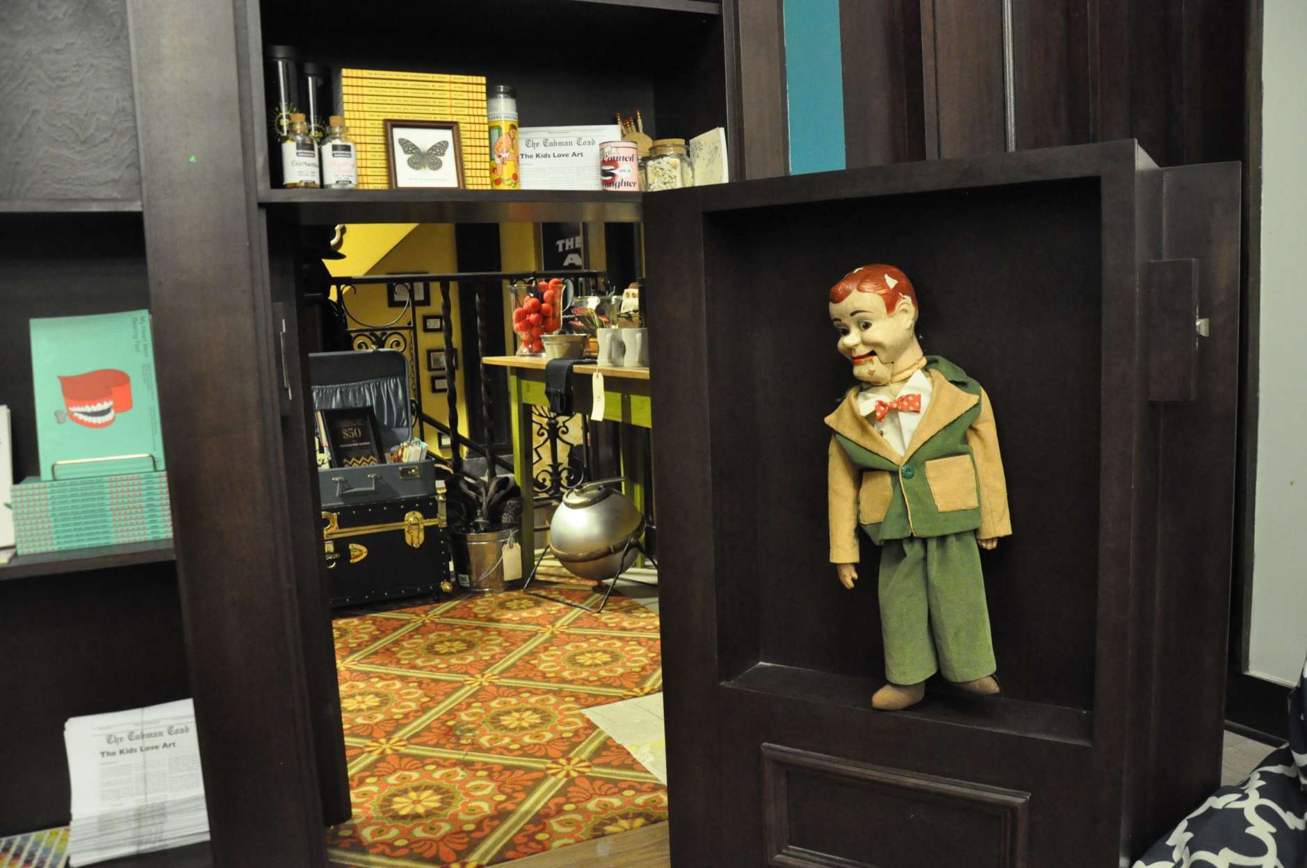 Inside Tivoli’s Astounding Magic Supply Company, wands, capes and candles are available for purchase. But behind a trap door — guarded by a ventriloquist doll — is where the real magic takes place. It's 826DC, a nonprofit writing center. (WTOP/Rachel Nania) 