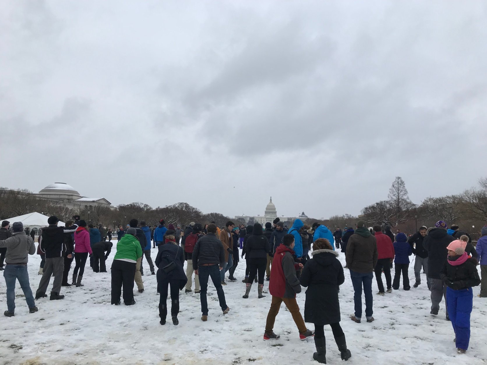 A group gathers at the National Mall on Wednesday, March 21, 2018, for a snowball fight. (WTOP/Dick Uliano)