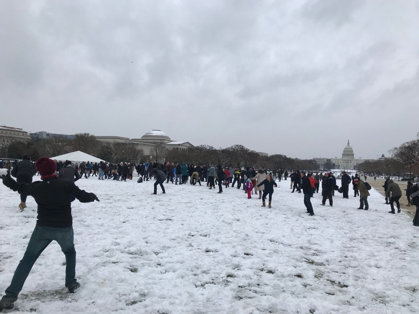 A snowball fight takes place at the National Mall during a spring snow storm on Wednesday, March 21, 2018. (WTOP/Dick Uliano)