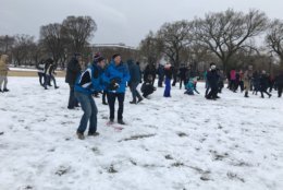 A man prepares to throw a snowball during a snowball fight that organized at the National Mall on Wednesday, March 21, 2018. (WTOP/Dick Uliano)