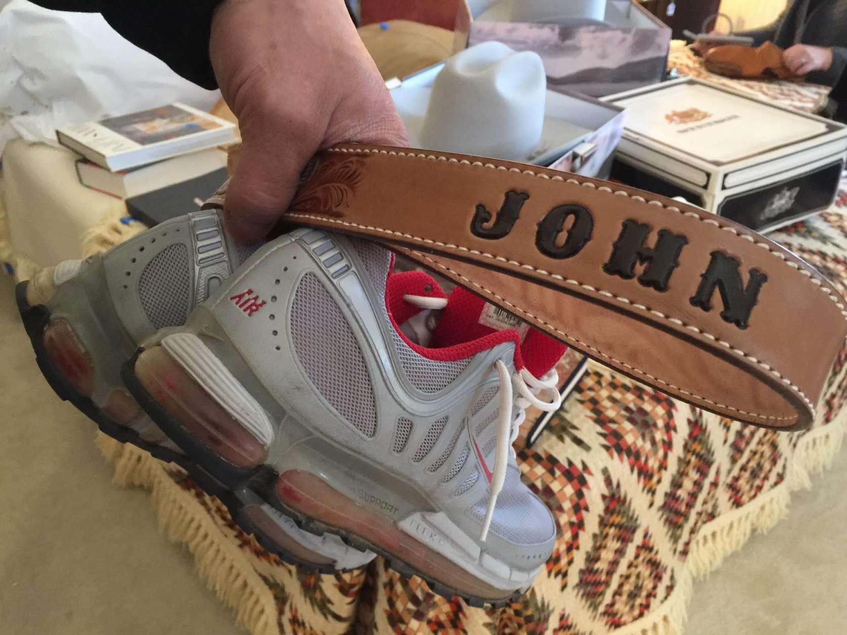 A belt and sneakers at John Glenn's estate sale. (WTOP/Kristi King)