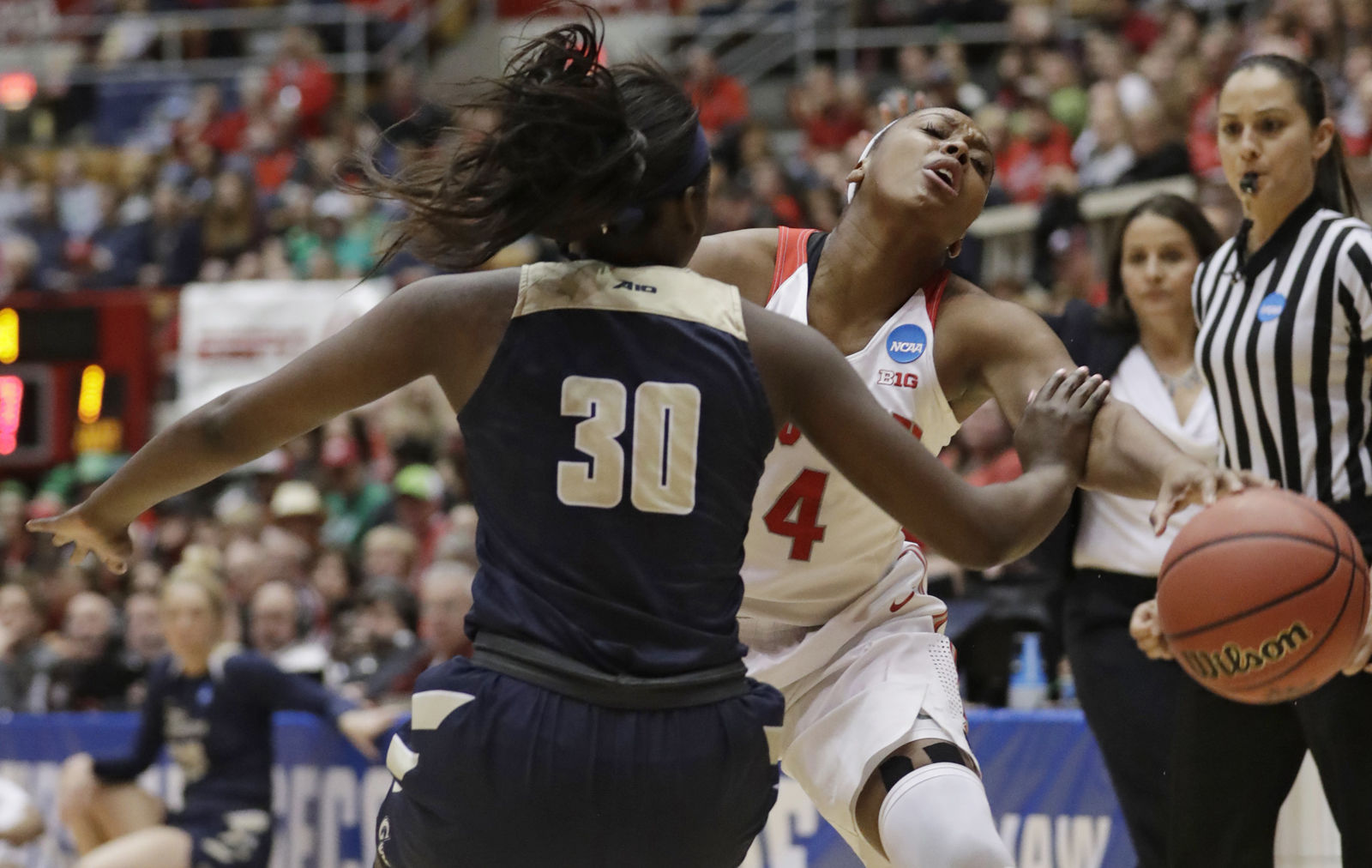 Ohio State's Sierra Calhoun, right, fouls George Washington's Neila Luma (30) in the first half during a first-round game in the NCAA women's college basketball tournament Saturday, March 17, 2018, in Columbus, Ohio. (AP Photo/Tony Dejak)