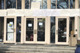 Signs put up by student protesters announce the administration building on Howard University's campus is closed. Students began a sit-in on Thursday night that closed the building. (WTOP/Melissa Howell)