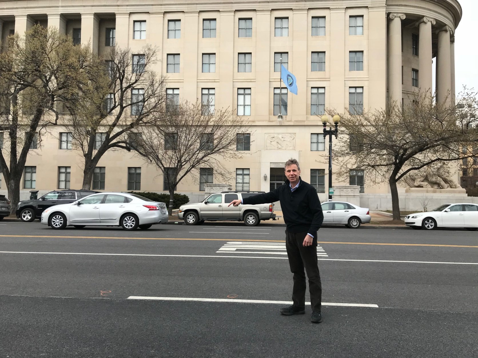 Author and historian Ken Ackerman points to the spot on Constitution Avenue where President James Garfield was assassinated in 1881. (WTOP/Dick Uliano)