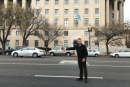 Author and historian Ken Ackerman points to the spot on Constitution Avenue where President James Garfield was assassinated in 1881. (WTOP/Dick Uliano)