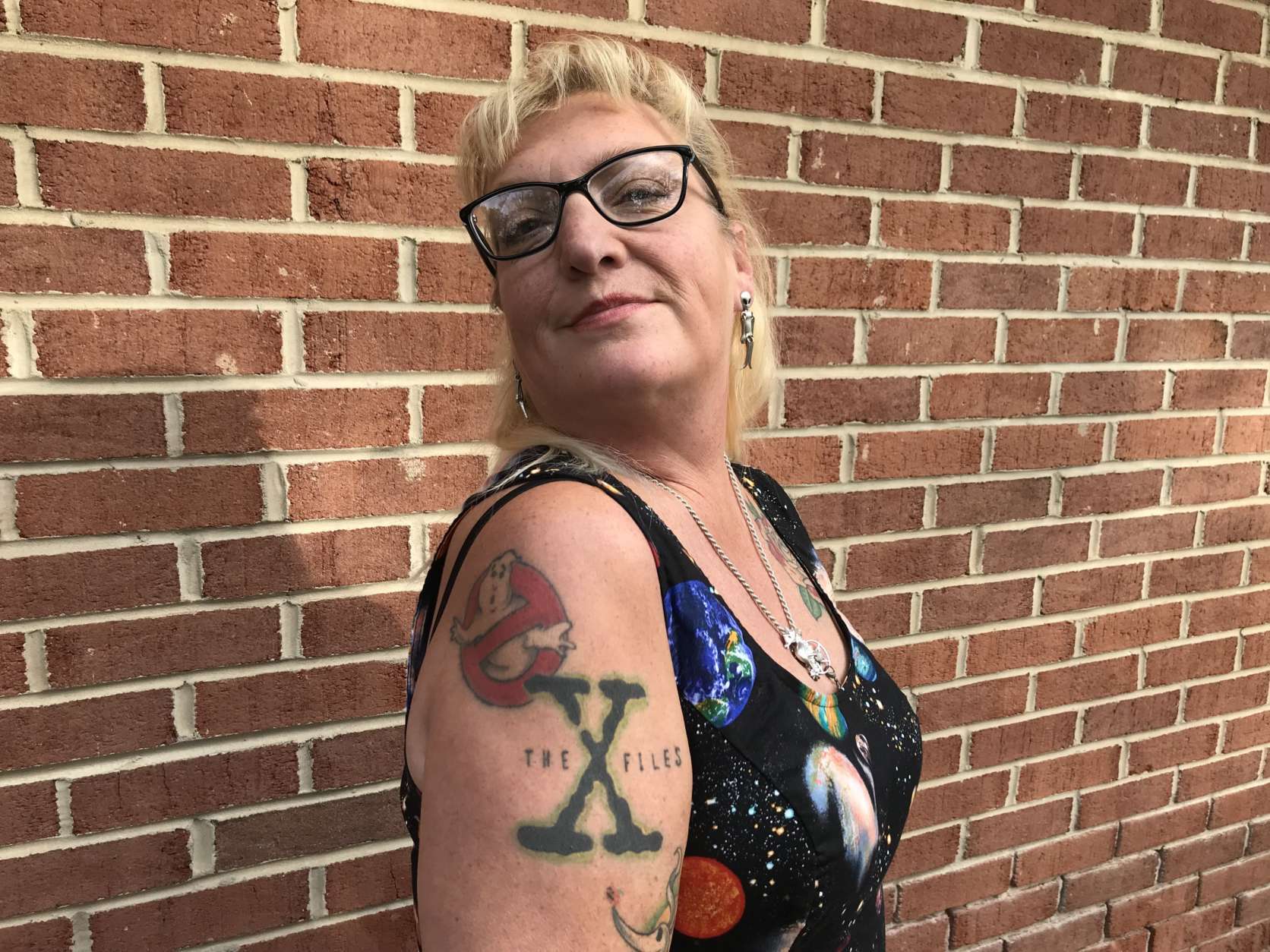 This woman attending the “Mysteries of Space and Sky” UFO conference last October in Gambrills, Maryland, showed off her Ghostbusters and X-Files tattoos. (WTOP/Michelle Basch)
