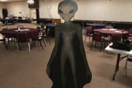 A cardboard cutout of a grey alien made an appearance at the “Mysteries of Space and Sky” conference in Gambrills, Maryland, this past October. (WTOP/Michelle Basch)