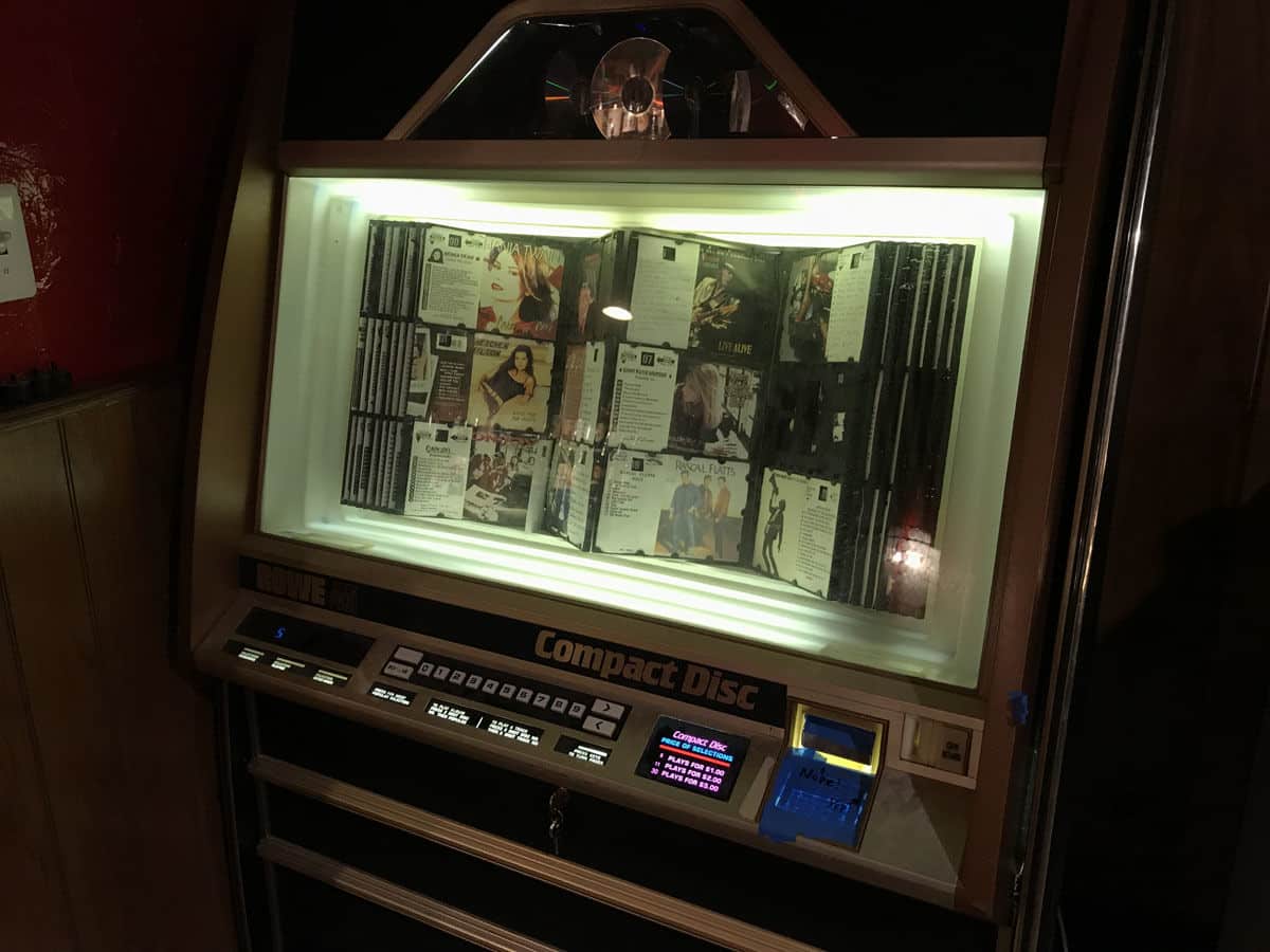 The owners traveled to the Pittsburgh area to buy the very same brand of CD jukebox that the tavern had before the 2015 fire. Ignore the CD art — the jukebox is being loaded with the same tunes it used to have, with a few additions. (WTOP/Michelle Basch)