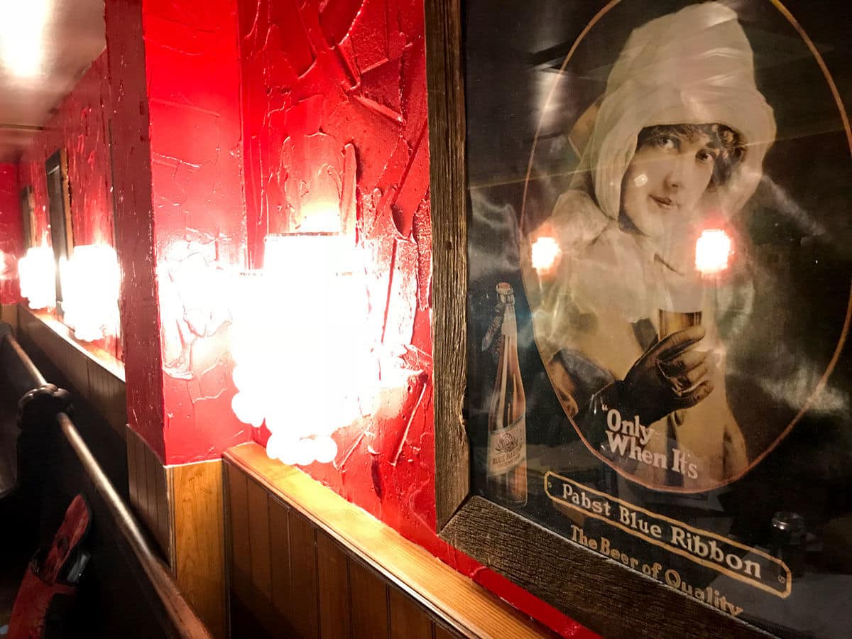 Vintage beer posters displayed on the walls were removed from the tavern after the 2015 fire, so they were not affected by the 2016 flood. Many are back on the walls again. (WTOP/Michelle Basch)