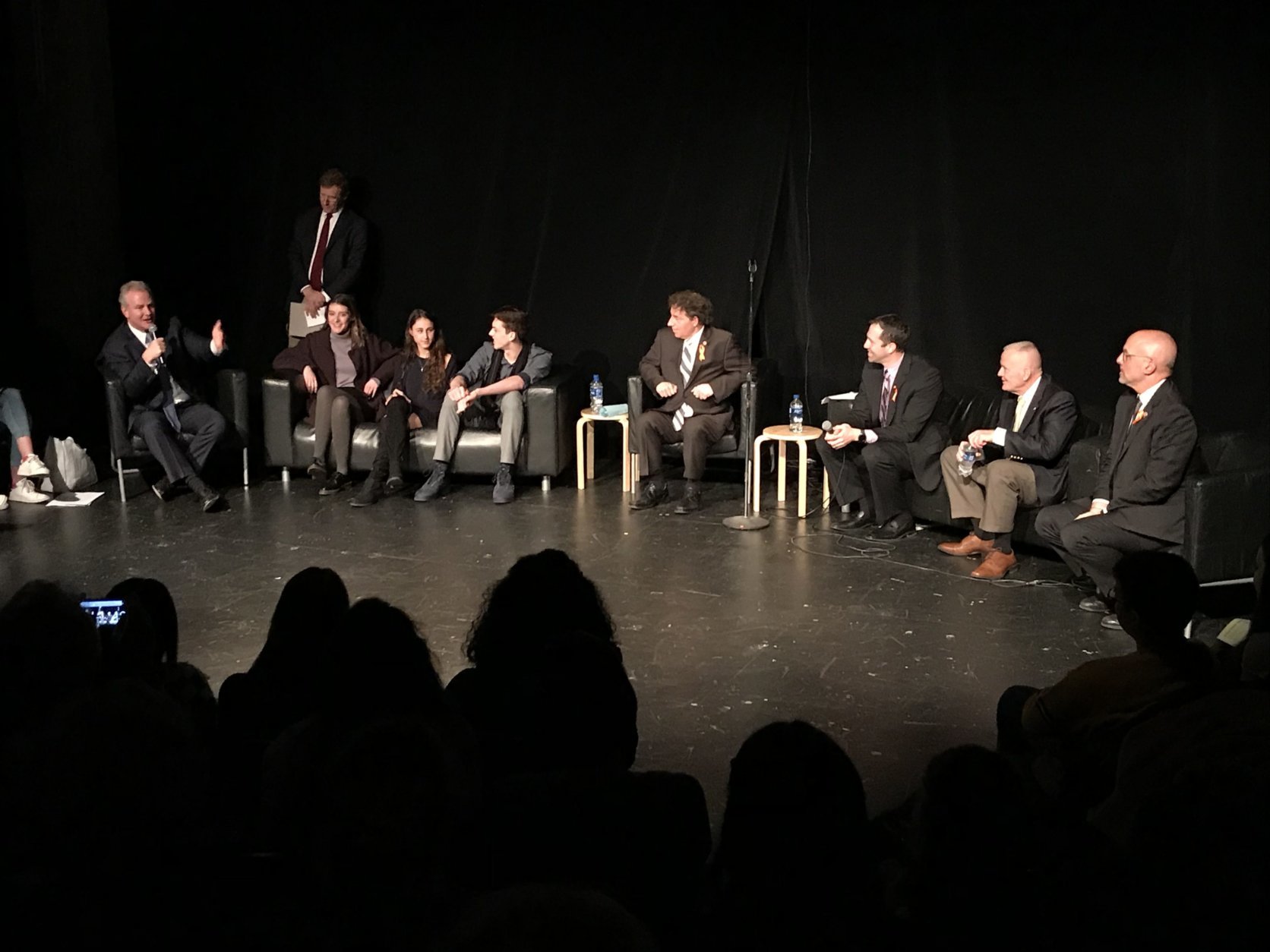 Sen. Chris Van Hollen, D-Md., (left, with microphone) was among the lawmakers who joined Bethesda-Chevy Chase High School students and others for a panel discussion about gun violence Tuesday, March 13, 2018. (WTOP/Michelle Basch)