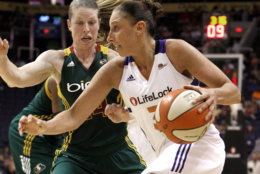The Phoenix Mercury's Diana Taurasi, right, drives past the Seattle Storm's Katie Smith during a WNBA basketball game, Tuesday, Aug. 16, 2011, in Phoenix.  The Mercury defeated the Storm 81-79. (AP Photo/Ross D. Franklin)