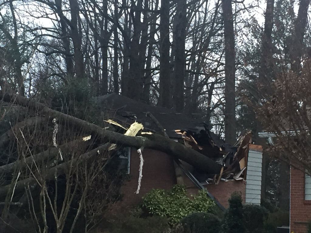 A clearer view of the damage done by a tree that fell on a home in Kensington, Maryland. A 100-year-old woman was taken to the hospital with non-life threatening injuries. (WTOP/John Domen)