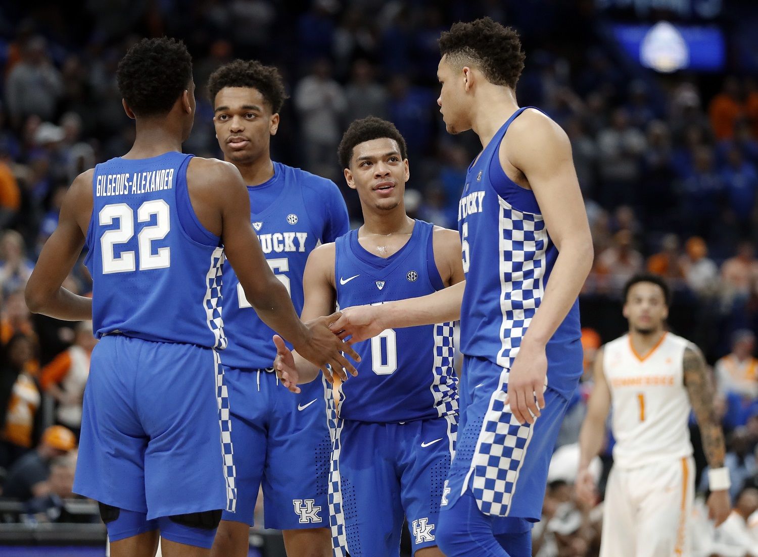 Kentucky's Shai Gilgeous-Alexander (22), PJ Washington (25), Quade Green (0) and Kevin Knox (5) celebrate in the final seconds of their win over Tennessee in an NCAA college basketball championship game at the Southeastern Conference tournament Sunday, March 11, 2018, in St. Louis. (AP Photo/Jeff Roberson)