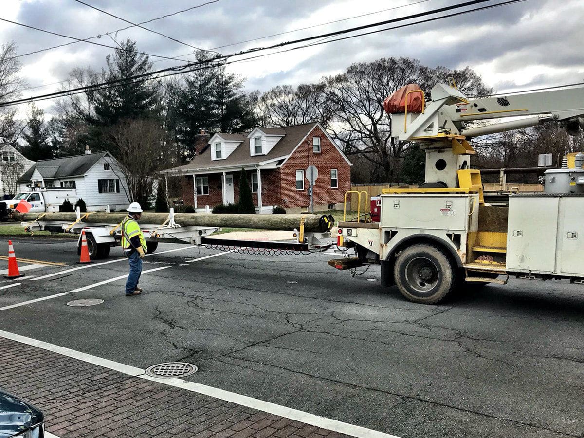 Crews arrive with replacement poles after the wind knocked down the poles in Leesburg, Virginia. (WTOP/Neal Augenstein)
