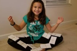 Melody Harlan of Warrenton is pictured having fun with more than 1,200 spelling cards she used to study for the Fauquier County Spelling Bee she recently won. (Courtesy, Tina Harlan)
