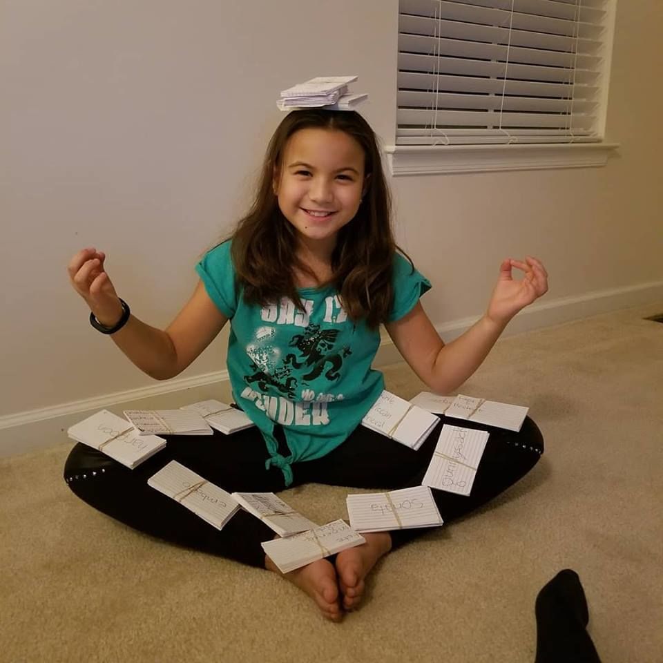 Melody Harlan of Warrenton is pictured having fun with more than 1,200 spelling cards she used to study for the Fauquier County Spelling Bee she recently won. (Courtesy, Tina Harlan)