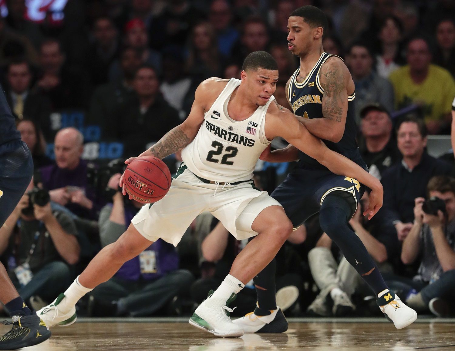 Michigan State guard Miles Bridges (22) drives against Michigan guard Charles Matthews (1) during the second half of an NCAA Big Ten Conference tournament semifinal college basketball game, Saturday, March 3, 2018, in New York. Michigan won 75-64. (AP Photo/Julie Jacobson)