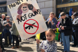 At D.C.'s March For Our Lives event on Saturday, March 24, 6-year-old Florence Morton from New York City holds up a sign that reads, "Protect Me Not Guns." (WTOP/Kate Ryan