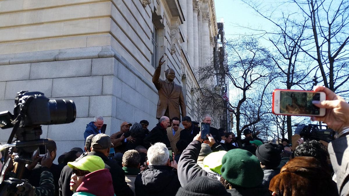 People snap up photos of the moment the statue is unveiled on Saturday, March 3, 2018. (WTOP/Kathy Stewart)