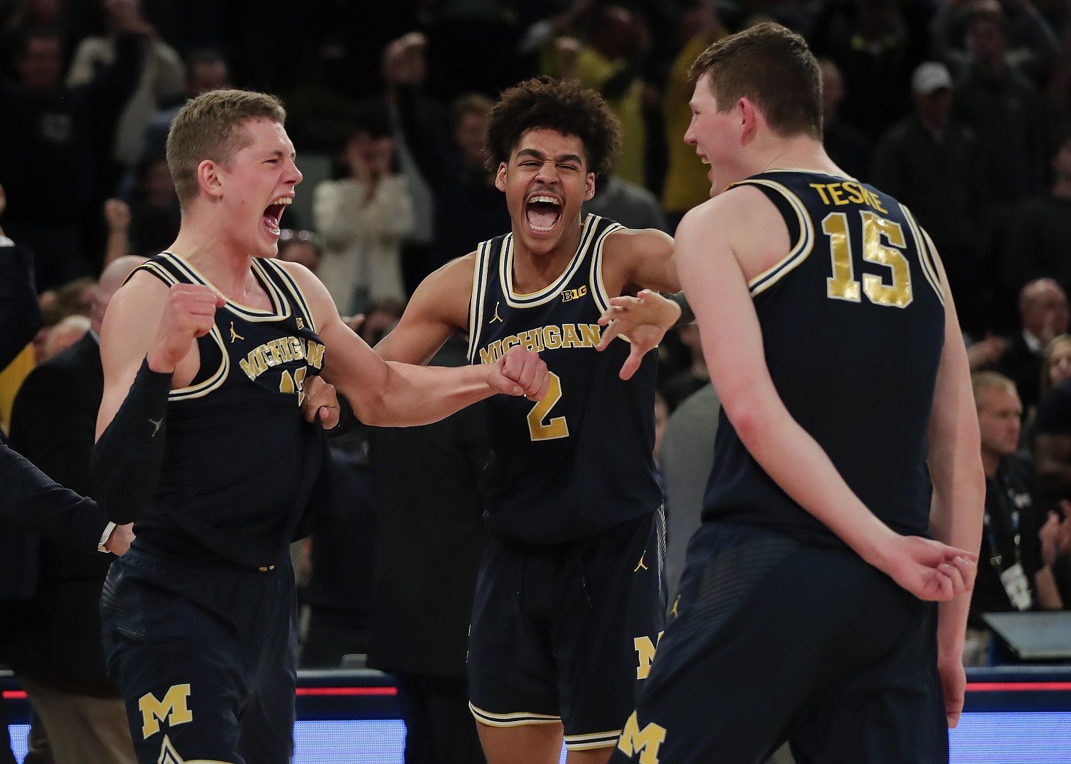 From left, Michigan forward Moritz Wagner, guard Jordan Poole (2) and center Jon Teske (15) celebrate after Michigan beat Purdue of the NCAA Big Ten Conference tournament championship college basketball game, Sunday, March 4, 2018, in New York. Michigan won 75-66. (AP Photo/Julie Jacobson)