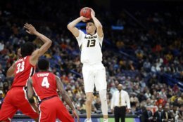 Missouri's Michael Porter Jr. shoots over Georgia's Nicolas Claxton (33) and Tyree Crump (4) during the first half in an NCAA college basketball game at the Southeastern Conference tournament Thursday, March 8, 2018, in St. Louis. (AP Photo/Jeff Roberson)