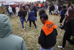 Students gather on their soccer field during a 17-minute walkout protest at the Stivers School for the Arts, Wednesday, March 14, 2018, in Dayton, Ohio. Students across the country planned to participate in walkouts Wednesday to protest gun violence, one month after the deadly shooting inside a high school in Parkland, Fla. (AP Photo/John Minchillo)