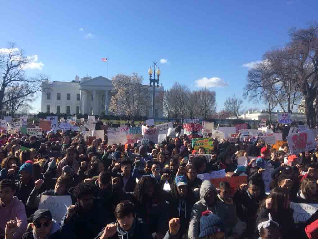 Scores of students sat in complete silence with their backs turned to the White House for 17 minutes beginning at 10 a.m. on March 14. (WTOP/Nick Iannelli)