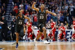 NASHVILLE, TN - MARCH 18:  Josh Hall #33 of the Nevada Wolf Pack celebrates with Hallice Cooke #13 after defeating the Cincinnati Bearcats during the second half in the second round of the 2018 Men's NCAA Basketball Tournament at Bridgestone Arena on March 18, 2018 in Nashville, Tennessee.  (Photo by Andy Lyons/Getty Images)