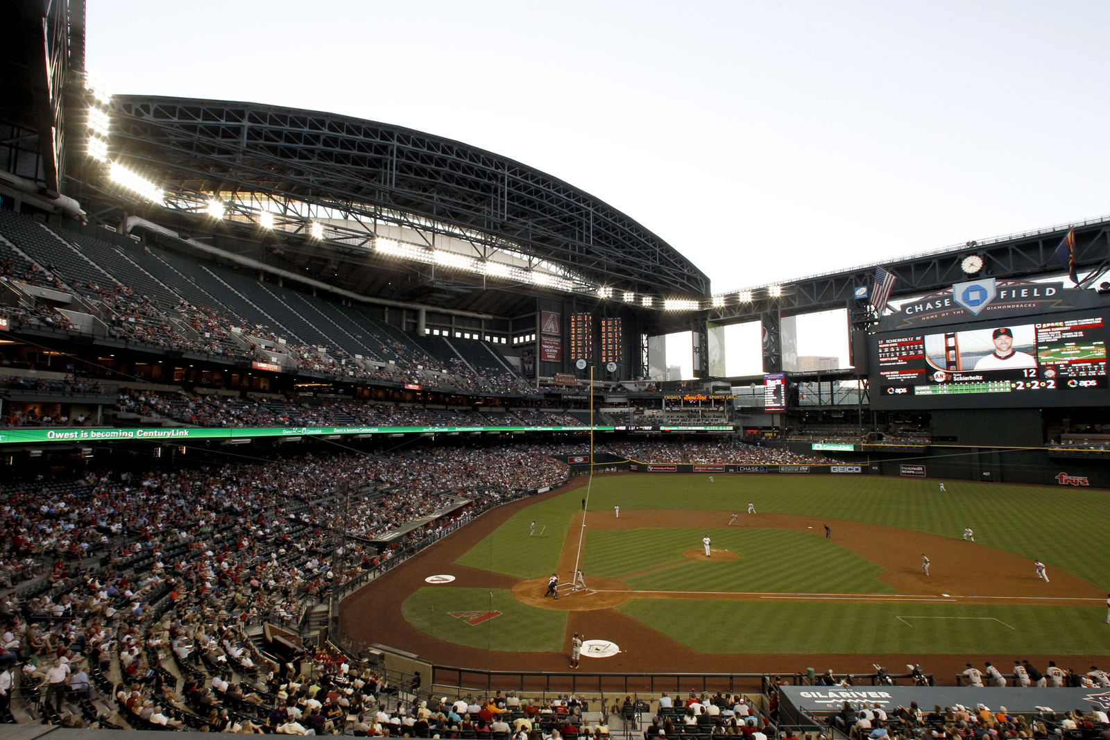 When Chase Field opened in 1998, it was the first stadium in the United States with a retractable roof over a natural-grass field. Twenty years after its opening, it's one of the cheaper stadiums to visit coming it No. 26 with an average cost of $56. File. (AP Photo/Ross D. Franklin)