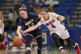American guard Emily Kinneston (4) fights for the ball against Navy guard Hannah Fenske (13) during the first half an NCAA college basketball game for the Patriot League women's tournament championship, Sunday March 11, 2018, in Washington. (AP Photo/Nick Wass)