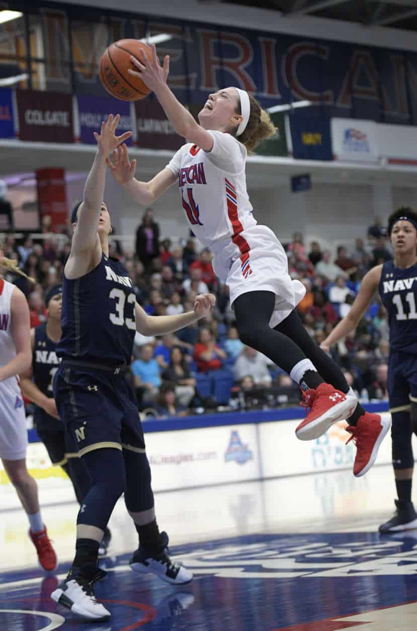 American guard Maria Liddane (14) goes to the basket against Navy guard Sophie Gatzounas (33) during the first half an NCAA college basketball game for the Patriot League women's tournament championship, Sunday, March 11, 2018, in Washington. (AP Photo/Nick Wass)