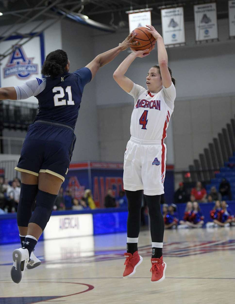 American guard Emily Kinneston (4) shoots against Navy guard Jasmine Bishop (21) during the first half an NCAA college basketball game for the Patriot League women's tournament championship, Sunday, March 11, 2018, in Washington. (AP Photo/Nick Wass)