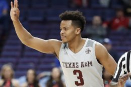 Texas A&amp;M's Admon Gilder gestures after making a 3-point basket during the first half in an NCAA college basketball game at the Southeastern Conference tournament Thursday, March 8, 2018, in St. Louis. (AP Photo/Jeff Roberson)