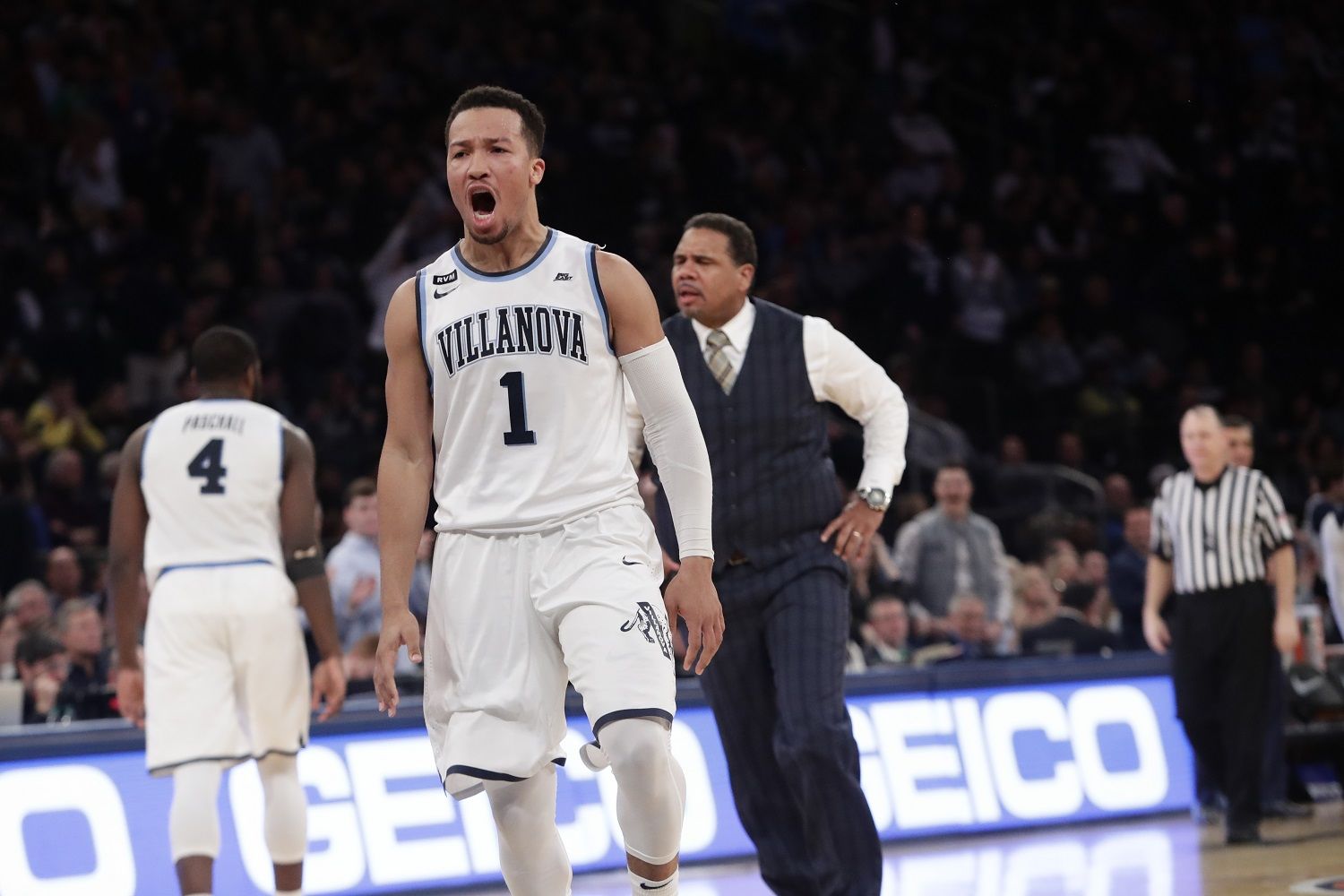 Providence head coach Ed Cooley, right, and Villanova's Jalen Brunson (1) react after Brunson made a three point basket during the second half of an NCAA college basketball game in the Big East men's tournament finals Saturday, March 10, 2018, in New York. (AP Photo/Frank Franklin II)