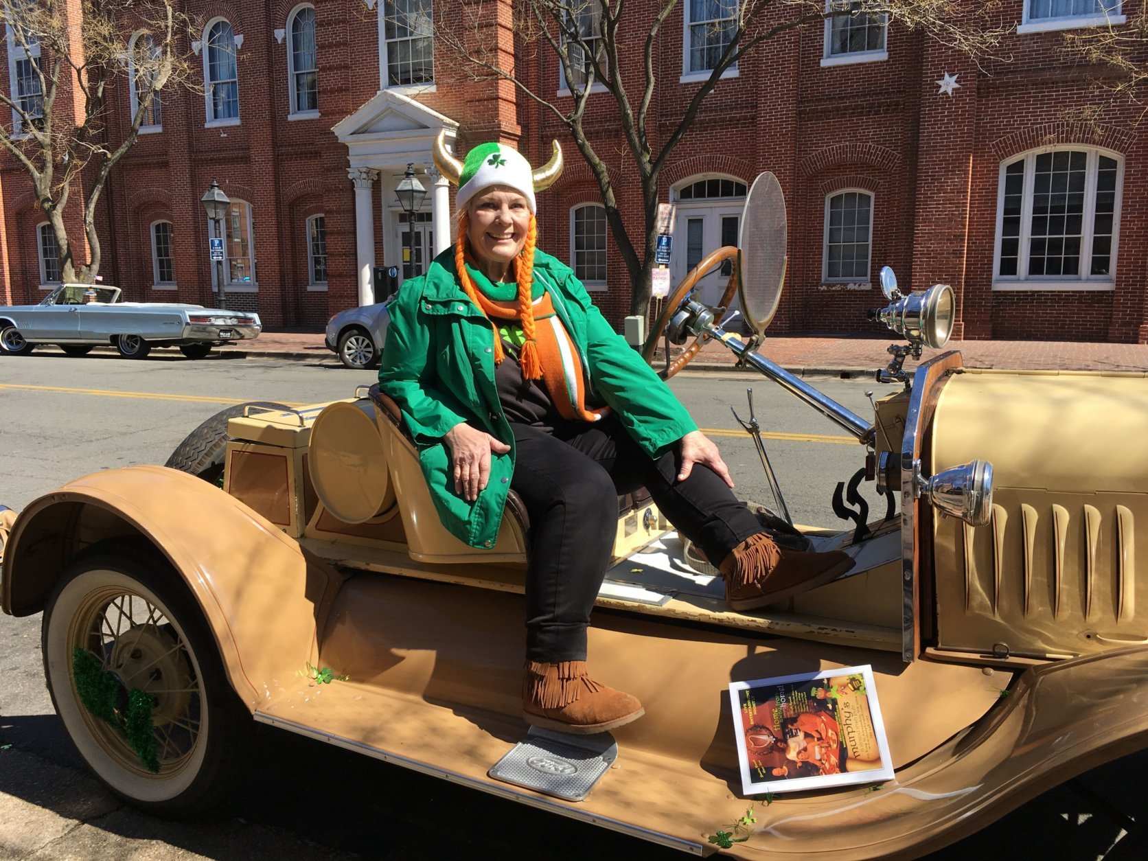 “I am Irish and I’m part Viking, hence the horns,” Debbie Bell told WTOP as she sat on the 1923 Model T Ford Speedster she and her husband brought up from Fredericksburg, Va. Bell donned a plush green and white helmet with a shamrock in the middle and gold horns pointed skyward. (WTOP/Liz Anderson)
