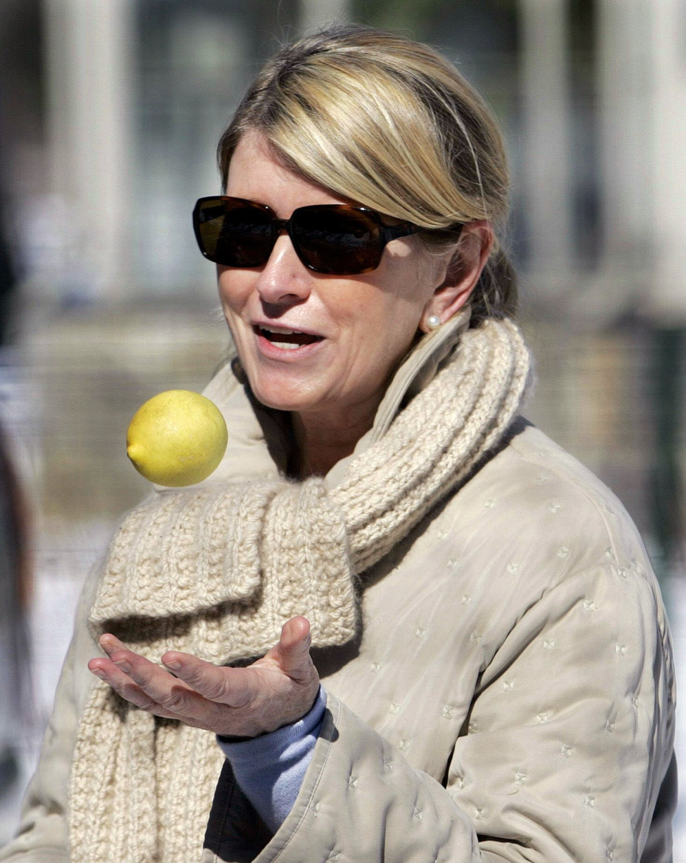 Martha Stewart tosses a lemon into the air outside of her home in Katonah, N. Y., Friday, March 4, 2005. Stewart refered to the saying about turning lemons into lemonade and said she was going inside to make hot lemonade. Stewart must spend the next five months in home confinement here at her $16 million New York estate.  (AP Photo/Ed Betz)