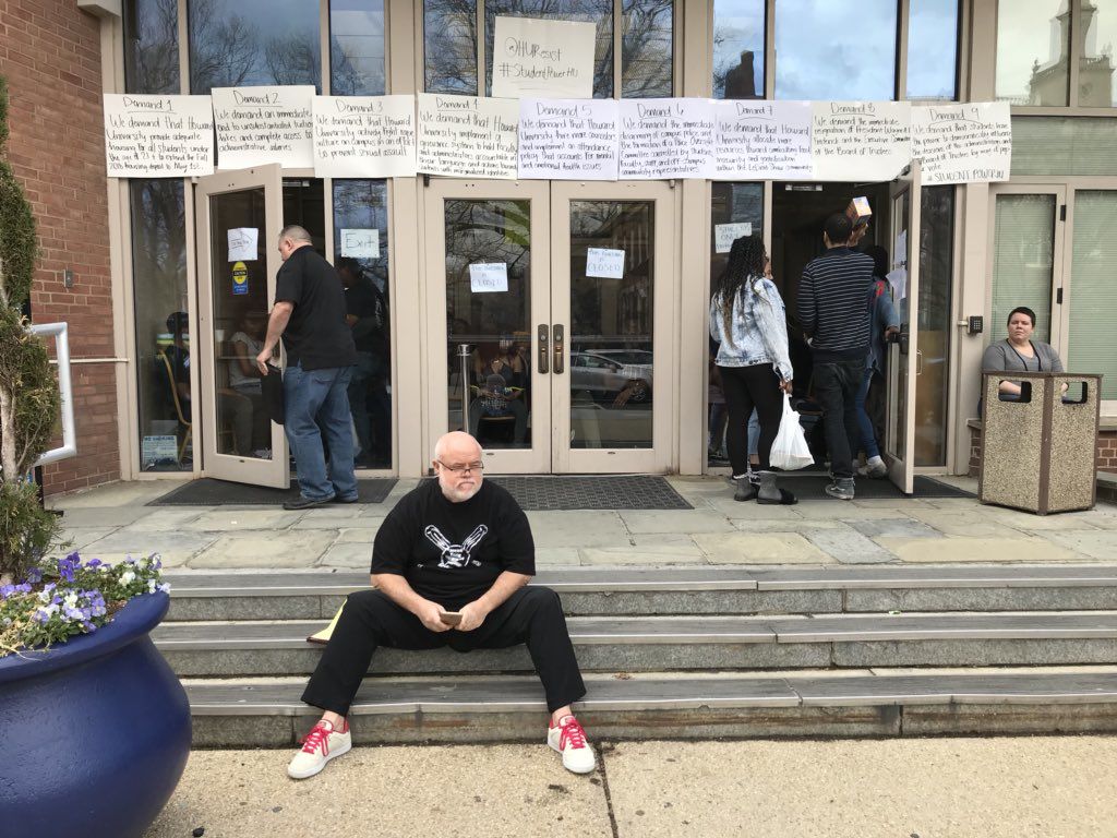 One member of the Howard board of trustees, Eugene “Rock” Newman, waits outside for Friday afternoon's meeting with protesters. (WTOP/Michelle Basch)