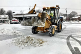 Photo shows a snow plow filled with snow
