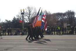 In this photo, people carry the flags of the U.S. and Ireland. (WTOP/Kathy Stewart)