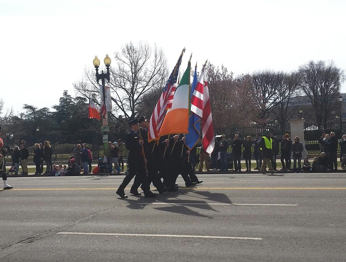 In this photo, people carry the flags of the U.S. and Ireland. (WTOP/Kathy Stewart)