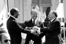 Egyptian President Anwar Sadat, left, U.S. President Jimmy Carter, center,  and Israeli Prime Minister Menachem Begin clasp hands on the north lawn of the White House after signing the peace treaty between Egypt and Israel on March 26, 1979. Sadat and Begin were awarded the Nobel Peace Prize for accomplishing peace negotiations in 1978. The rest of the Arab world shunned Sadat, condemning his initiative for peace. President Carter was pivotol for the two leaders to meet at Camp David and as a result, peace began between Arabs and Jews. (AP Photo/ Bob Daugherty)