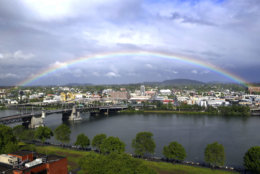 A rainbow pops out under dark rain clouds over the Willamette River in downtown Portland, Ore., Thursday, May 11, 2017. (AP Photo/Don Ryan)