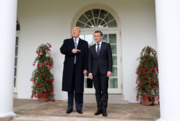 President Donald Trump points toward French President Emmanuel Macron as they walk along the White House collonade after a State Arrival Ceremony on the South Lawn in Washington, Tuesday, April 24, 2018. (AP Photo/Pablo Martinez Monsivais)