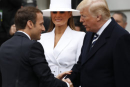 President Donald Trump, right, greets French President Emmanuel Macron as first lady Melania Trump looks on during a State Arrival Ceremony on the South Lawn of the White House in Washington, Tuesday, April 24, 2018. (AP Photo/Carolyn Kaster)