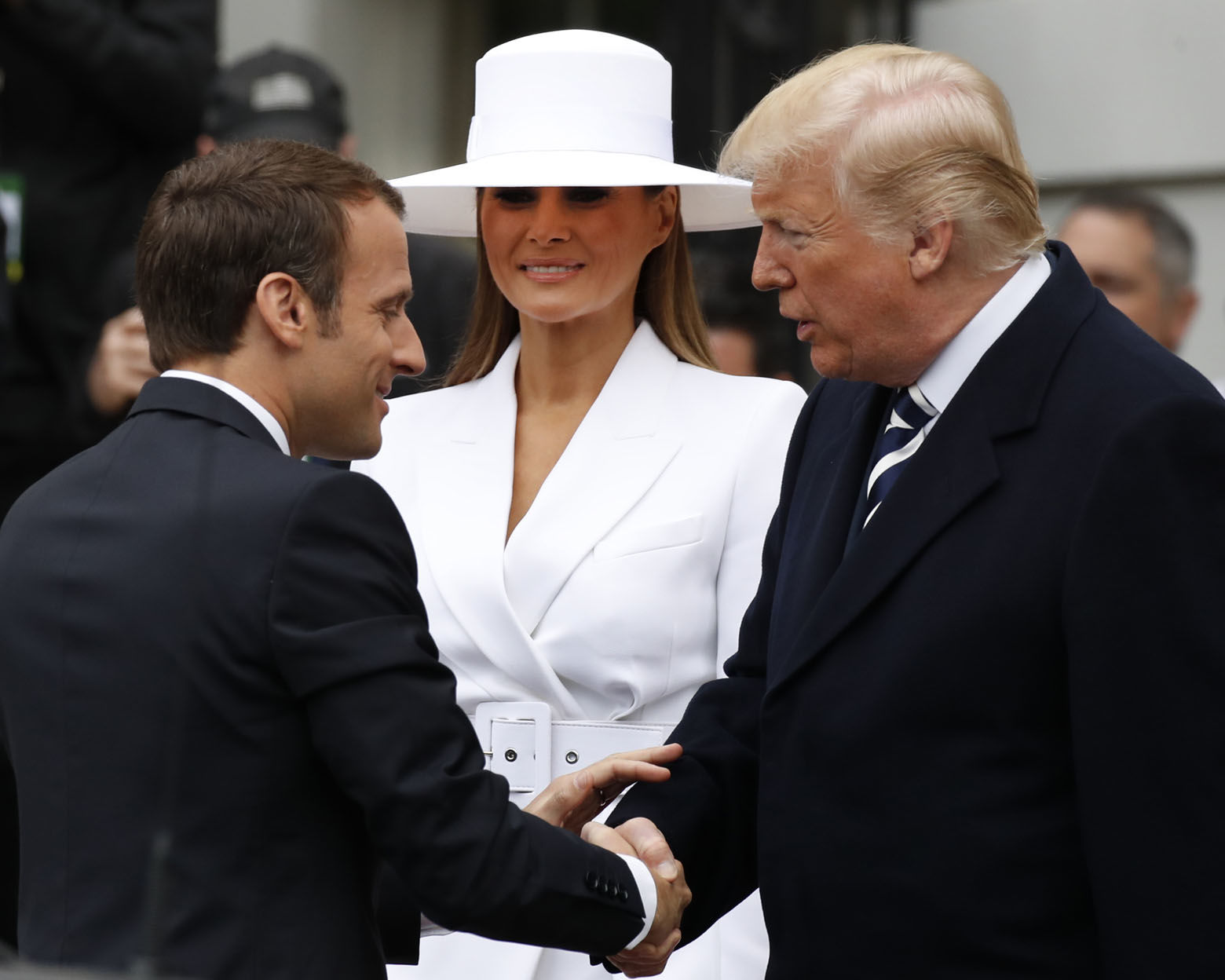 President Donald Trump, right, greets French President Emmanuel Macron as first lady Melania Trump looks on during a State Arrival Ceremony on the South Lawn of the White House in Washington, Tuesday, April 24, 2018. (AP Photo/Carolyn Kaster)