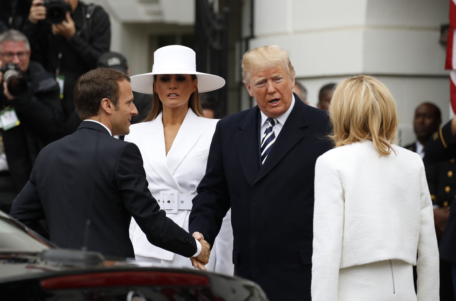 President Donald Trump and first lady Melania Trump welcome French President Emmanuel Macron and his wife Brigitte Macron during a State Arrival Ceremony on the South Lawn of the White House in Washington, Tuesday, April 24, 2018. (AP Photo/Carolyn Kaster)