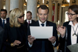 French President Emmanuel Macron and his wife Brigitte read a document during their visit to the Library of Congress on Wednesday, April 25, 2018, in Washington. (AP Photo/Jose Luis Magana)